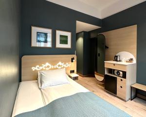 a bedroom with a bed and a table and a mirror at Hotell Bondeheimen in Oslo