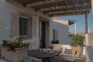 a patio with a table and chairs and a window at Ataraxia in Aroniadika