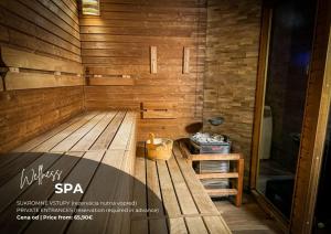 a sauna with a wooden floor and a stool at Hotel Modena in Bratislava
