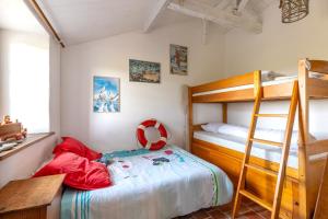 a bedroom with a bunk bed and a ladder at L’Échappée du Port - Grand Jardin in Bouin