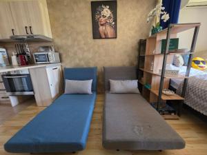 a living room with two blue benches in a room at Golden Lady in Sveti Vlas