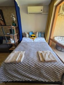 a bedroom with a large bed with a pumpkin on it at Golden Lady in Sveti Vlas +23 photos