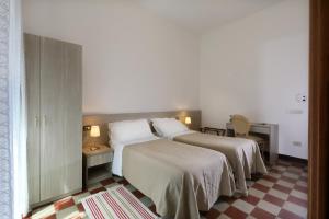 a hotel room with two beds with white sheets at Villa Astoria in Taormina