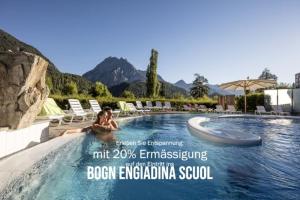 a poster for a resort with a woman in a swimming pool at CURUNA Pensiun-Frühstückspension in Scuol