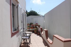 a patio with a table and chairs on a balcony at le case dei Pescatori Le coralline in Isola di Gavi