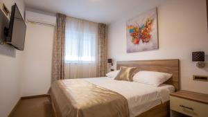 Postel nebo postele na pokoji v ubytování Rooms & Apartments Toni