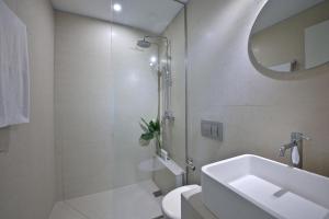 a bathroom with a sink and a toilet and a mirror at Magnificent Athens Villa 1 Bedroom Villa Aizen Garden View Ground Floor Platia Agion Asomaton in Athens