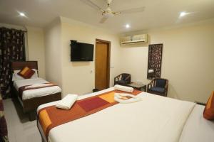 Voodi või voodid majutusasutuse Hotel O Ravin toas