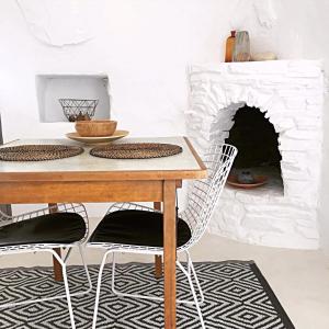 a dining room with a table and a fireplace at Cute Antiparos Villa 1 Bedroom Villa Sunset Amazing Sea Views in Andiparos