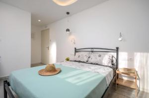 a bedroom with a bed with a hat on it at Naxos Central Room Double Room Private Balcony City Views Close To The Beach Saint George in Naxos Chora