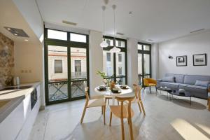 a kitchen and living room with a table and chairs at Delightful Athens Villa 1 Bedroom Villa Toshiro Thissio View Platia Agion Asomaton in Athens