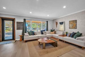a living room with a couch and a table at Newly Renovated - Sunny Family Haven in Pompano in Pompano Beach