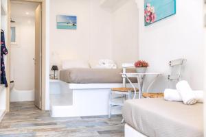 a small room with a bed and a bathroom at Luxury Naxos Suites Superior Triple Studio 150M From Agios Georgios Beach City Center Saint George in Naxos Chora +23 photos