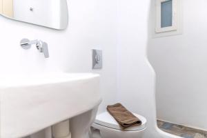 a white bathroom with a sink and a toilet at Luxury Naxos Suites Superior Triple Studio 150M From Agios Georgios Beach City Center Saint George in Naxos Chora