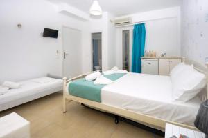 a white bedroom with a bed and a mirror at Superb Naxos Apartment Triple Studio Semi-Basement Private Balcony City Views Saint George in Naxos Chora