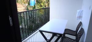 a table and two chairs on a balcony at Smile Residency in Sultan Bathery