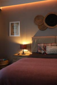 a bedroom with a bed and a lamp on a night stand at One Luxury House Above The Sea in Plakias