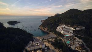 an aerial view of a beach with a cruise ship at Cala San Miguel Ibiza Resort, Adults only, Curio Collection by Hilton in Puerto de San Miguel