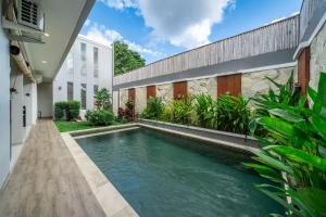 a swimming pool in the backyard of a house at Modern 3BDR Villa - Between Canggu & Seminyak in Kerobokan