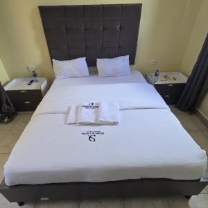 a bed with two towels sitting on top of it at Desert Sky Hotel in Isiolo