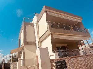 a white house with a fence in front of it at Airport Sea View - Studio - 15 mins from Athens Airport in Artemida