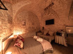 a bedroom with a bed in a stone wall at I CAVALIERI in Terlizzi