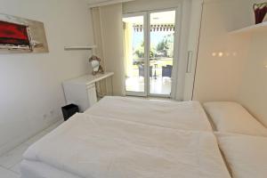 Ένα ή περισσότερα κρεβάτια σε δωμάτιο στο Residenza Ascomonte, Parterre, App 29 by HolAp SA