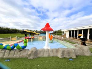 a water park with a playground with a mushroom at The Captain's Cabin in Petten