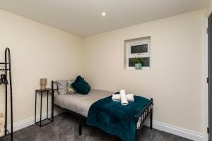 a bedroom with a bed and a window at Victoria Cottage Seaside - Spacious 4-BR in Bognor Regis,close to Beachfront & 2 minutes from Butlins Holiday Camp in Felpham