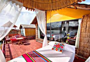 a living room with a couch and a balcony at Titicaca posada del sol lodge in Puno