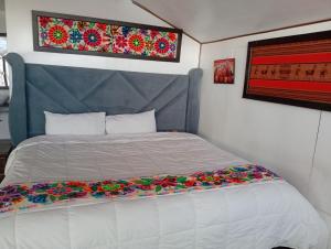 a bedroom with a bed with flowers on it at Titicaca posada del sol lodge in Puno