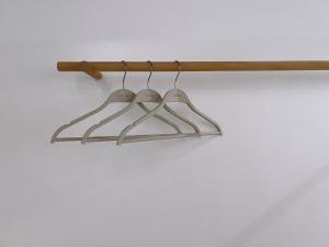 a rack with three hangers on a wall at 泊寓 boyü in Lukang