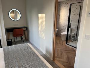 a bathroom with a mirror and a table and a chair at Thrumster Lodges - 3 Luxurious Self Catering Lodges on the NC500, 2 with Hot Tubs in Wick +54 photos