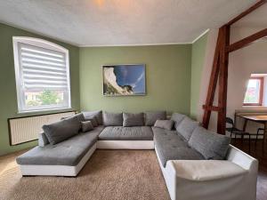 a living room with a couch and a table at Beautiful apartment for 5-7 guests in Zeitz