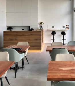 a dining room with wooden tables and chairs at HQ Arena Hotel in Valencia