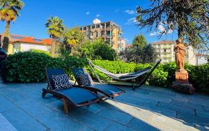 two chairs and a hammock on a patio at Villa Marchesa in Arona