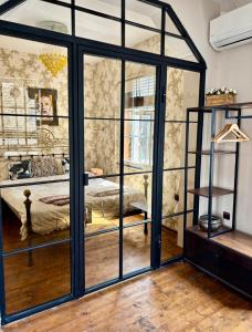 a room with a bed in a room with glass walls at ArtCity Villa- Historic Residence in Kapana in Plovdiv