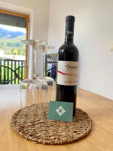 a bottle of wine and a glass on a table at Apartment Iris in Bohinj