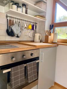 a kitchen with a stove and a counter top at Apartment Iris in Bohinj +23 photos