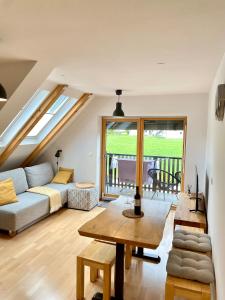 a living room with a couch and a table at Apartment Iris in Bohinj
