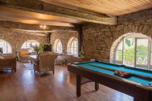 a pool table in a room with stone walls at La Tannerie - St Antonin Noble Val in Espinas