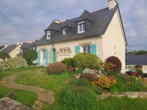 a white house with a black roof at Chez Pascal et Paula in Grâces