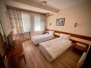 Voodi või voodid majutusasutuse Hotel Ilinden toas