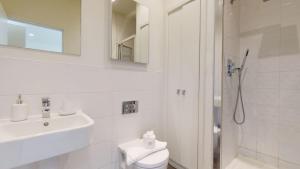 a bathroom with a shower and a toilet and a sink at Luxury Apartment - Town Centre North Stevenage in Stevenage +11 photos