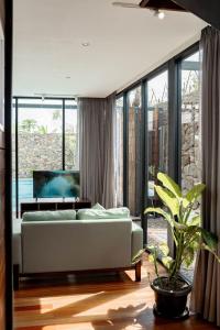 a living room with a couch and a large window at Desagha Cabin in Bandung +36 photos