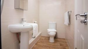 a bathroom with a sink and a toilet at StayZo Castle Point 18 Apartments - Premier Lodge in Southampton