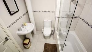 a bathroom with a toilet and a sink and a shower at StayZo - Executive City Centre Apartment 2 in Bradford