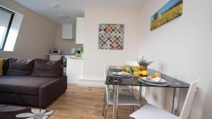 a living room with a table and a couch at StayZo Serviced Accommodation 16 Premier Lodge in Southampton