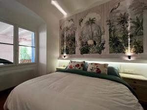 ein Schlafzimmer mit einem großen weißen Bett mit zwei Kissen in der Unterkunft Appartement Ombragé 44m2 Riviera Palace Belle-Epoque, Restomod et Literie Prestige in Menton