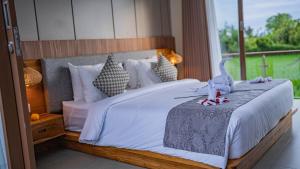 Ένα ή περισσότερα κρεβάτια σε δωμάτιο στο Three B Villas Canggu